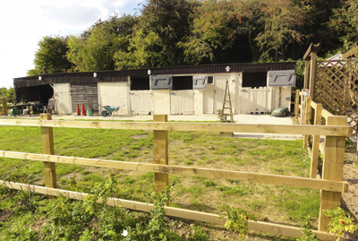 Paddock and stable block as seen from the wildflower meadow.
