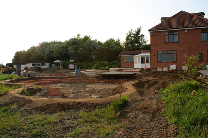 The decking is completed and the sand lining for the pond has started to appear.