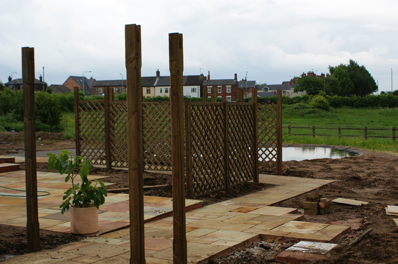 The trellises are starting to go up.
