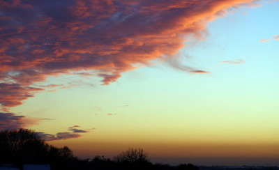 Storm clouds gather over the valley as the sun sets